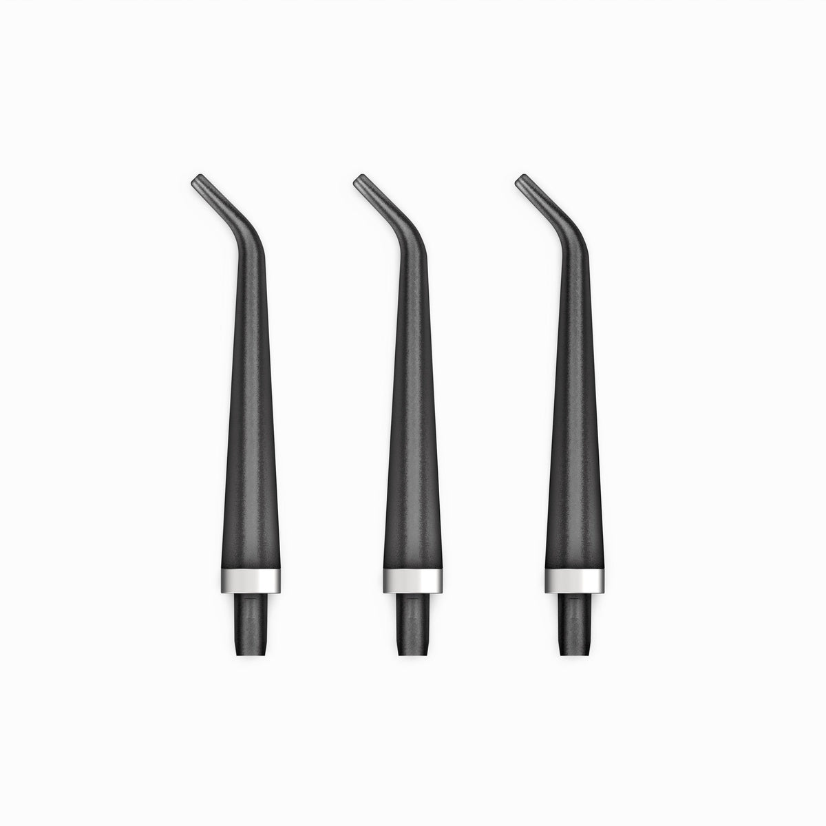 Three black dental nozzles with silver bases on a white background