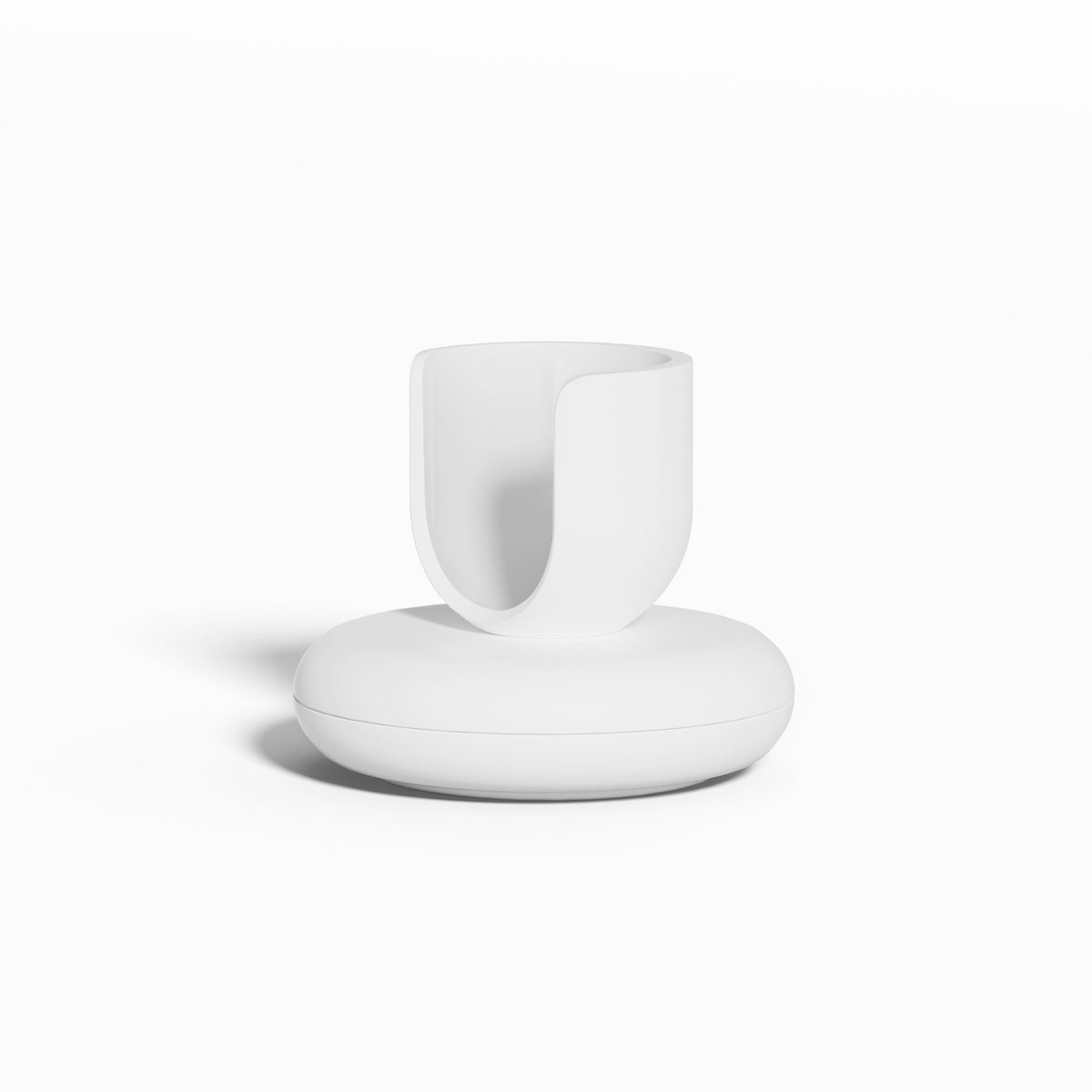 White Rev Stand featuring a rounded base and an open, U-shaped holder for supporting a toothbrush, shown against a clean white background.