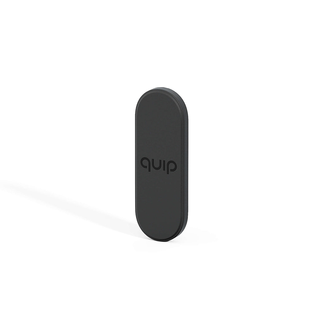 A black quip Ultra Mirror Mount designed to hold a toothbrush on a mirror or other flat surface.
