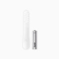 An extra soft brush head refill next to a battery, designed for a sonic electric toothbrush.